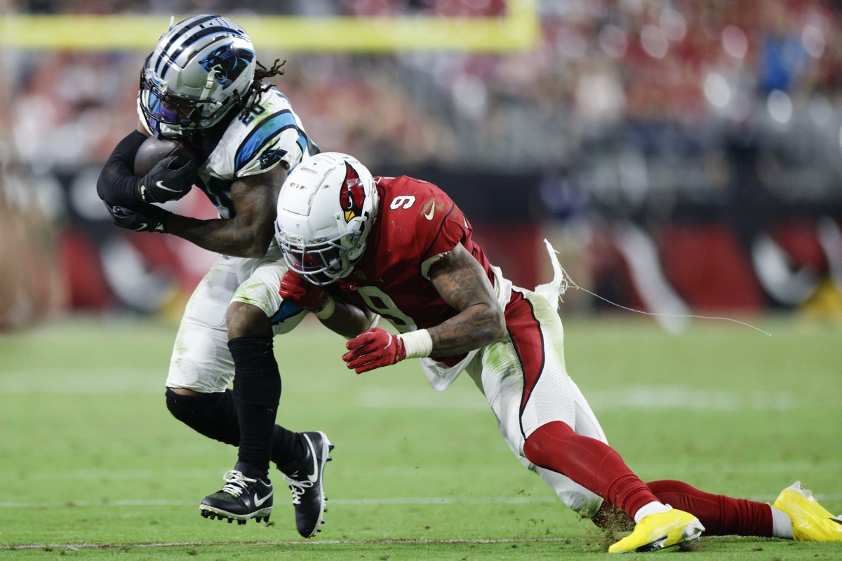 running back Ameer Abdullah runs with the ball in his hands as Arizona Cardinals linebacker Isaiah Simmons leans to tackle him